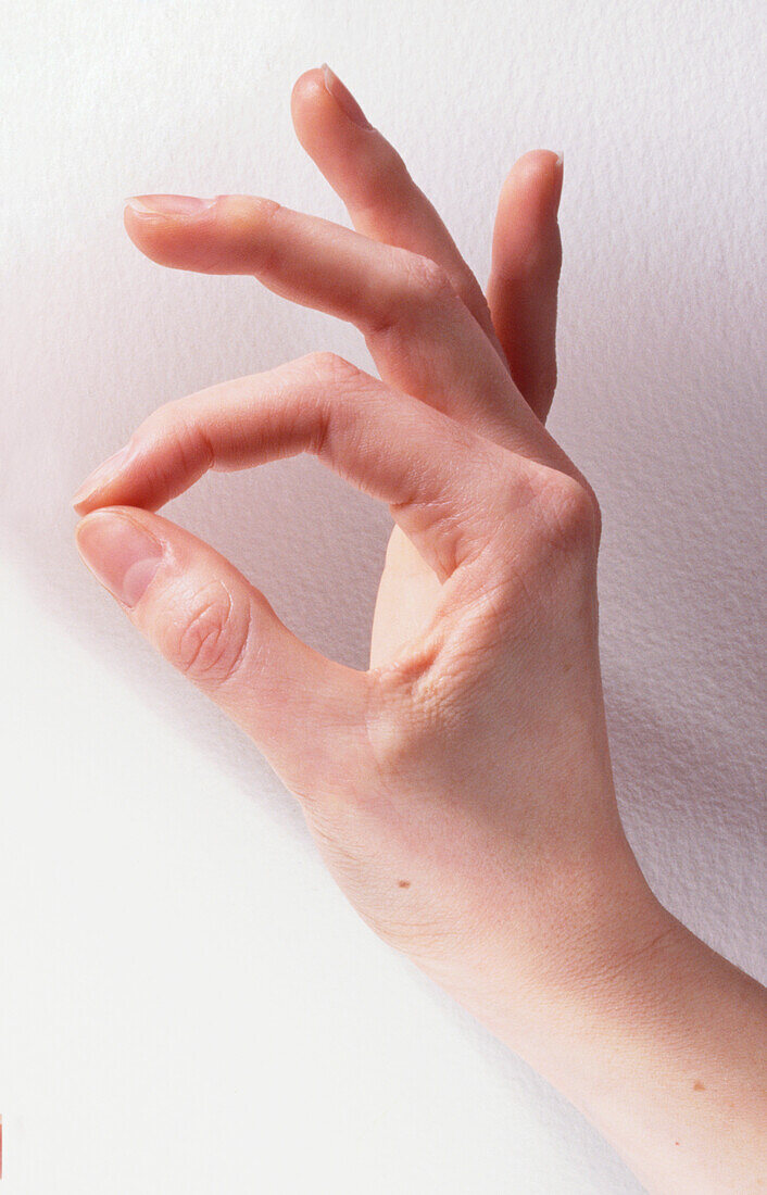 Tips of index finger and thumb pressed together