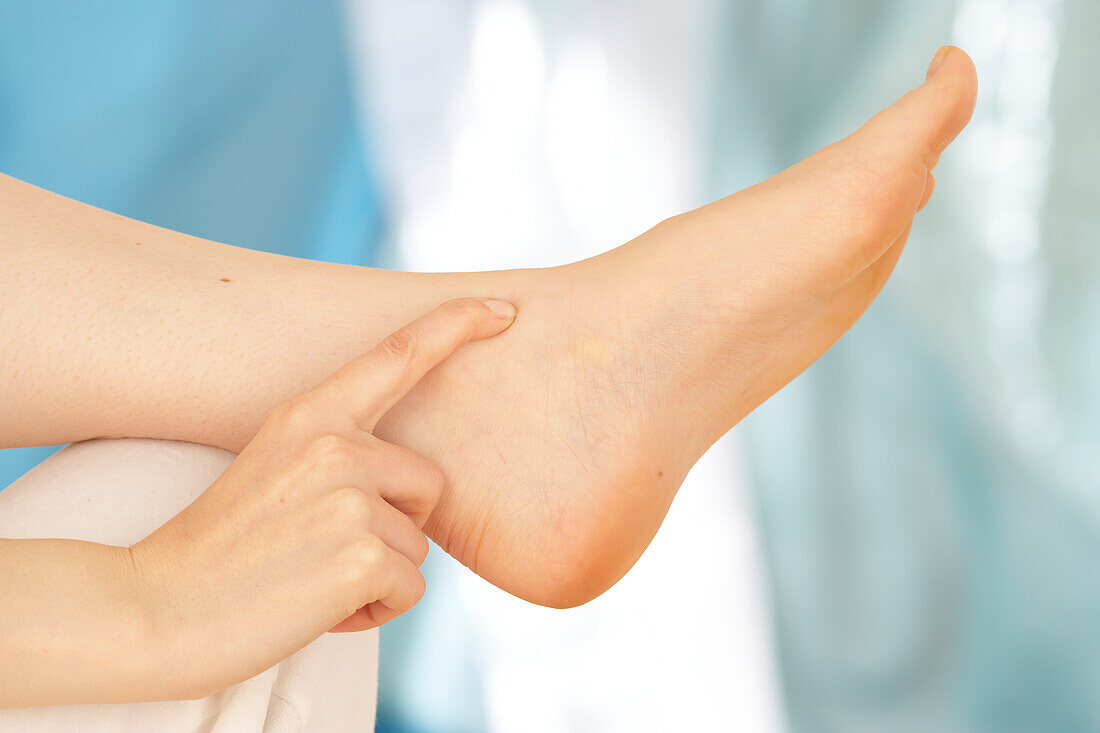 Woman massaging foot using finger walking technique