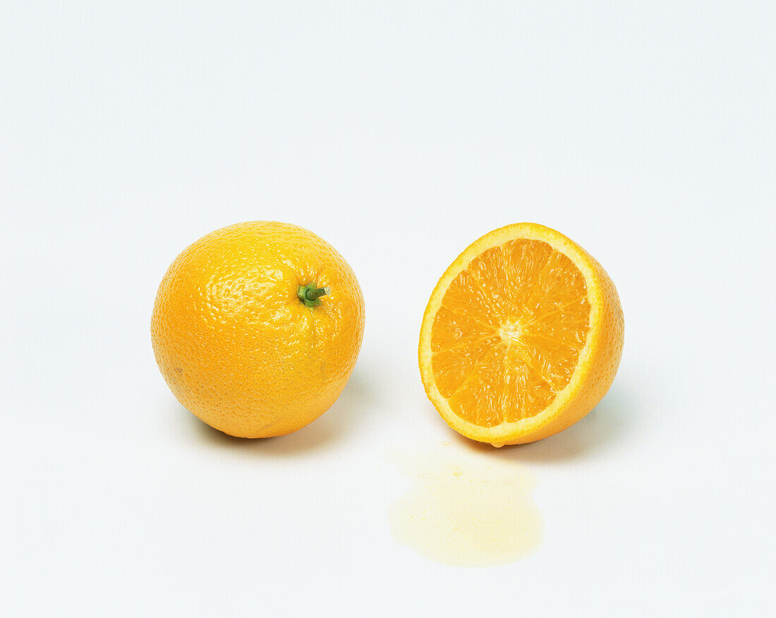 Whole orange and a halved orange