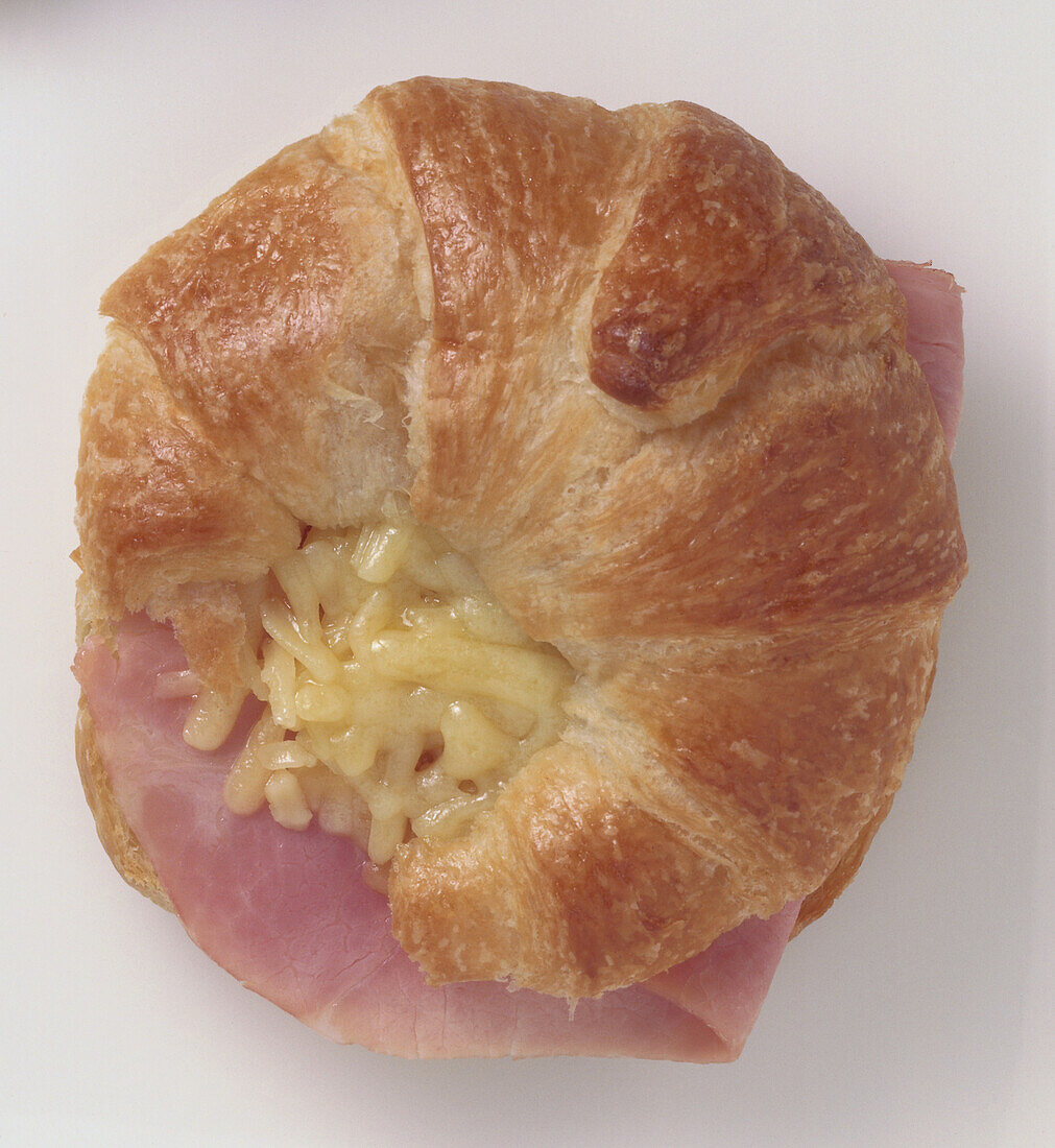 Croissant filled with grated cheddar cheese and ham