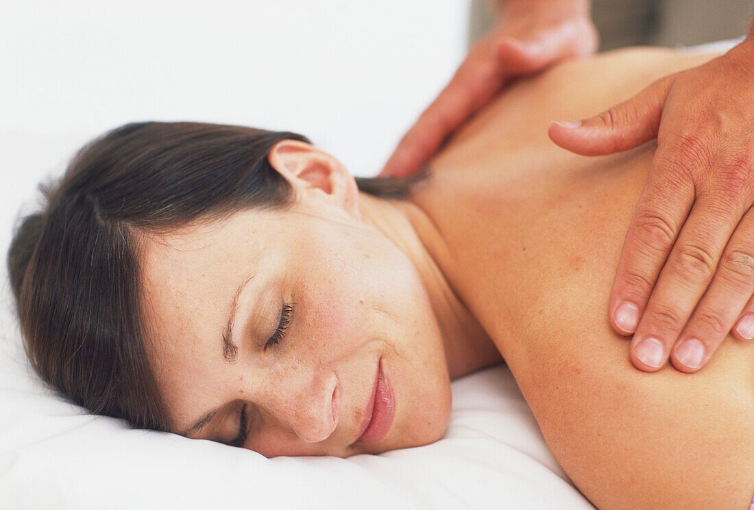 Woman having her back massaged