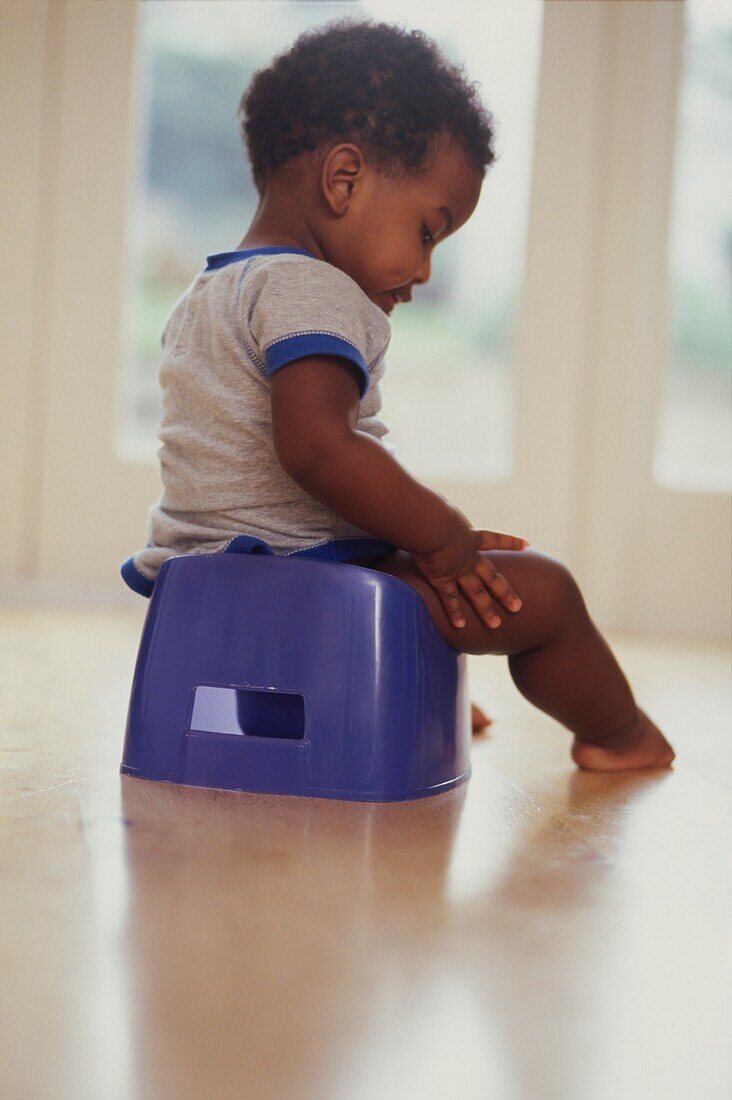 Baby boy sitting on potty