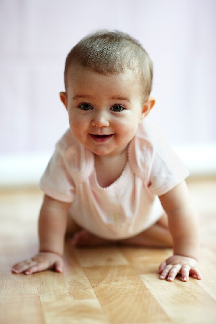 Baby girl crouching