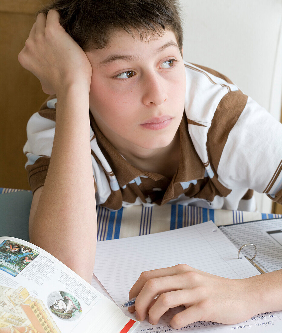 Boy sitting in front of his homework