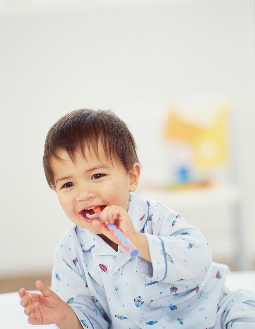 Boy with a toothbrush in his mouth