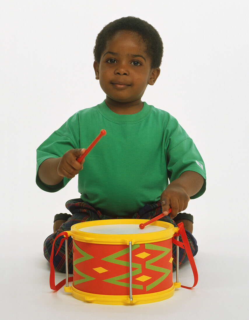 Small boy playing a drum