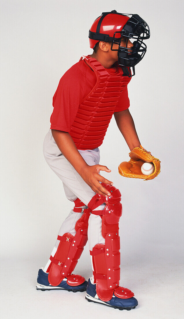 Boy dressed in baseball protective clothing