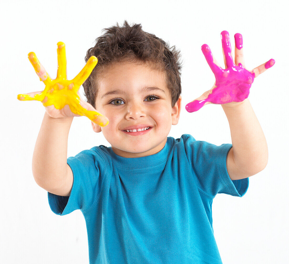 Boy with paint on his hands and face