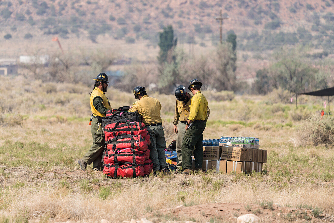 Crew stacking supplies and fluids for fire crews