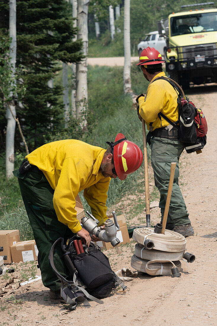 Firefighter assembling gear to fight a forest fire