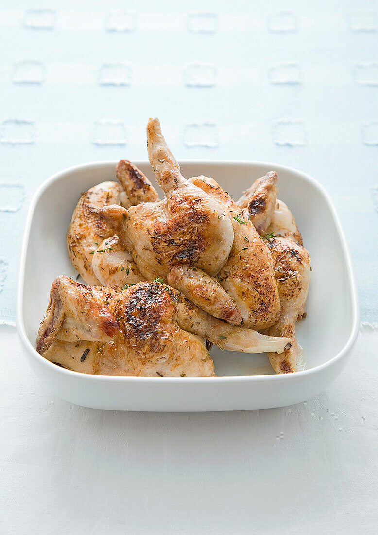 Grilled poussins in bowl