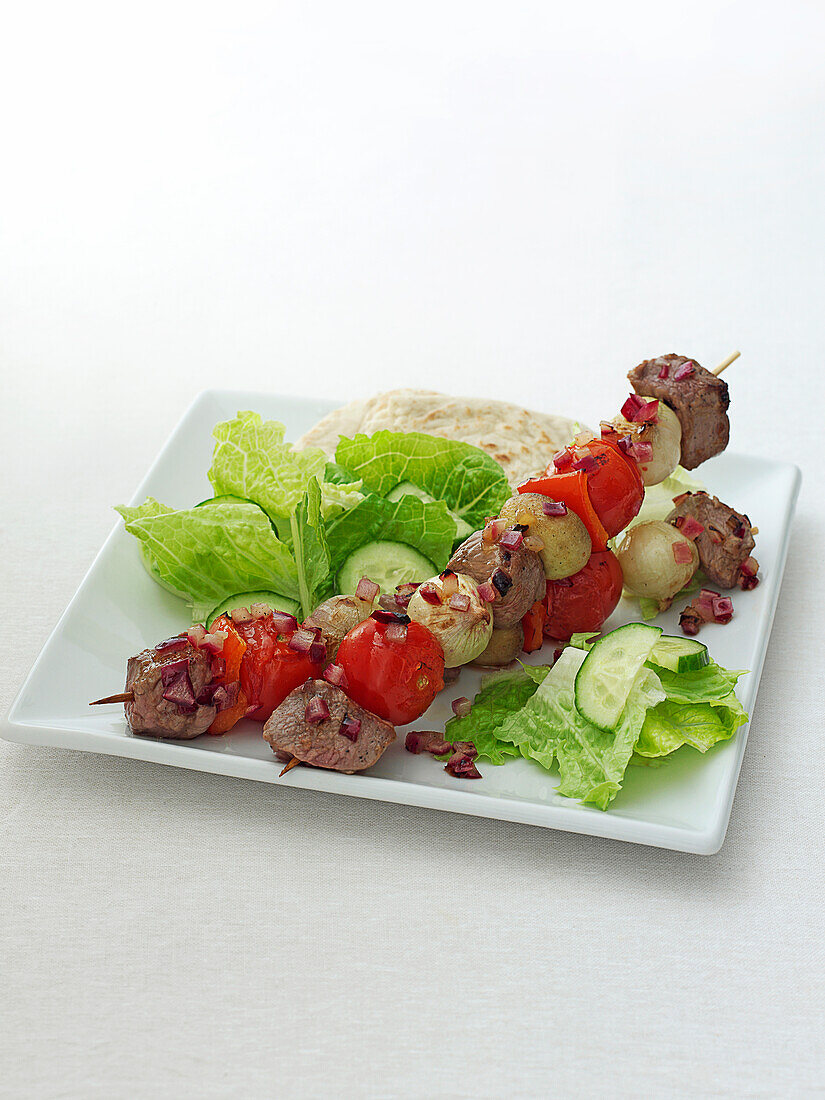 Kebabs with salad on plate