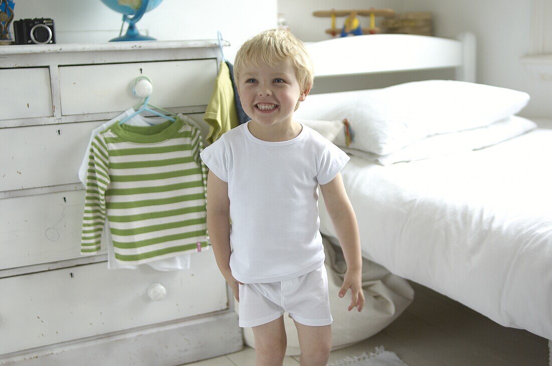Boy wearing white vest and pants