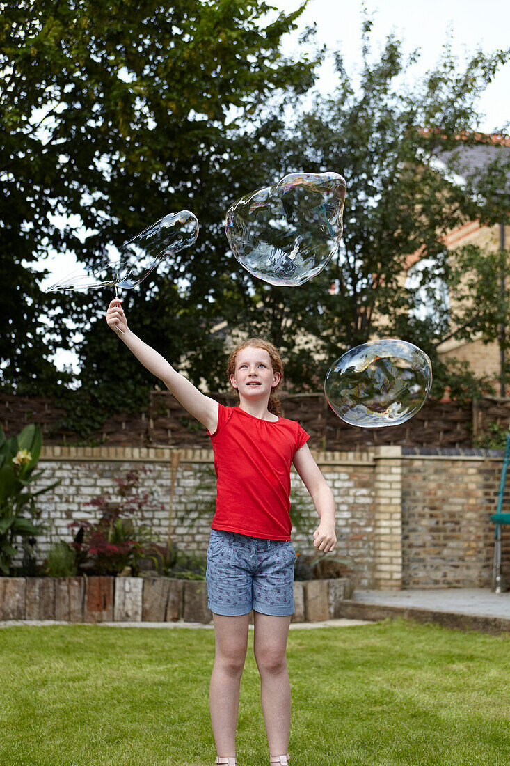 Making bubbles using wire clothes hanger as bubble wand