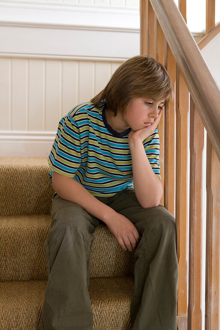 Boy sitting on stairs