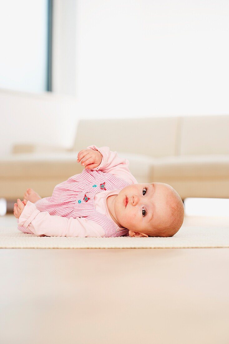 Baby girl rolling on the floor