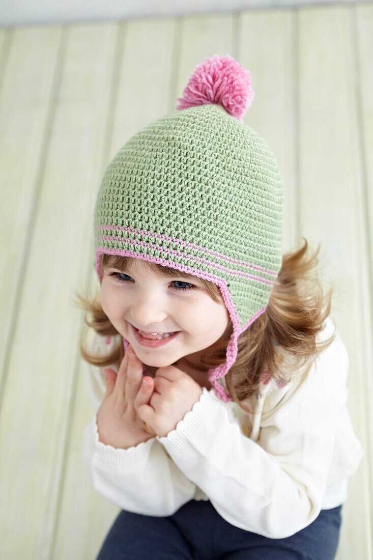 Girl wearing crocheted earflap hat