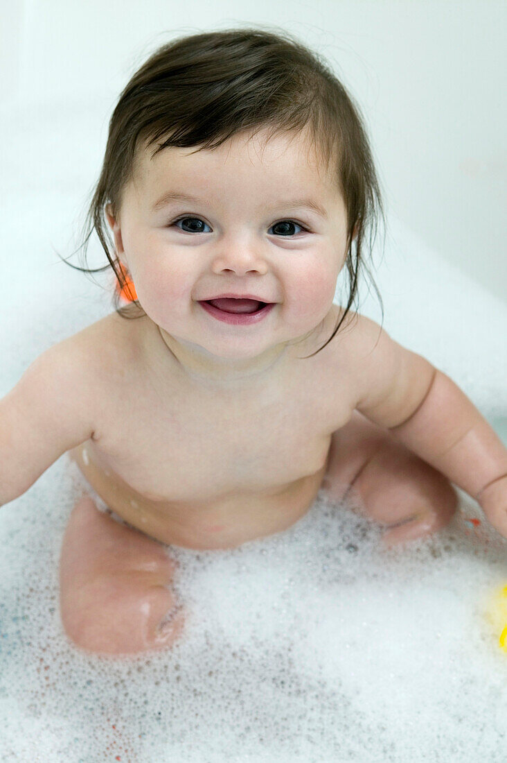 Baby girl sitting in bath