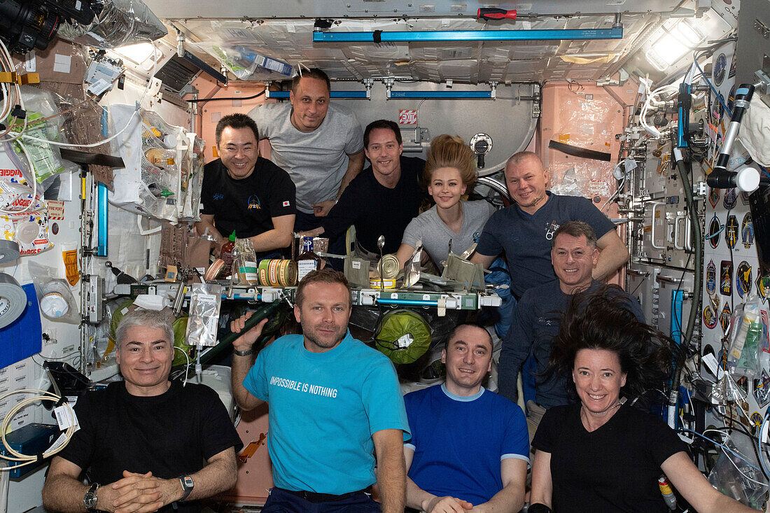 Group portrait of astronauts and space tourists on the ISS