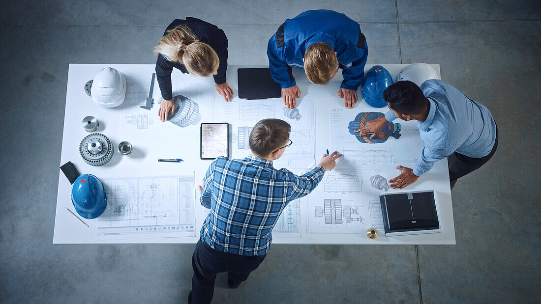 Team of industrial engineers leaning on a office table