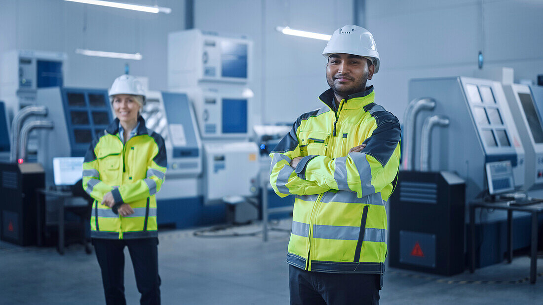 Smiling engineers working in a factory