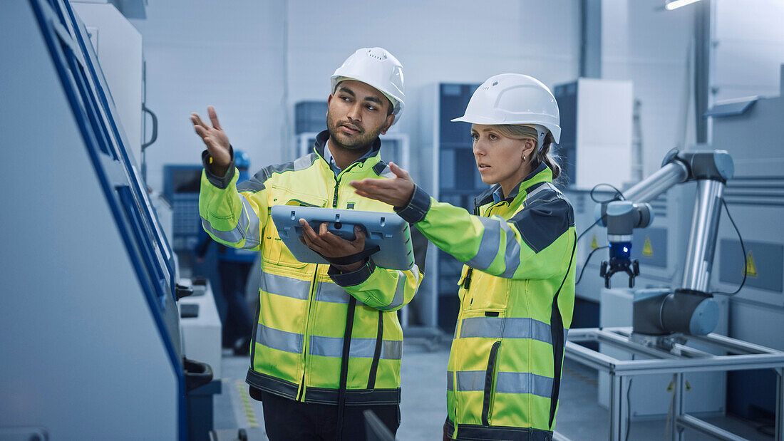 Engineer and manager using a digital tablet controller