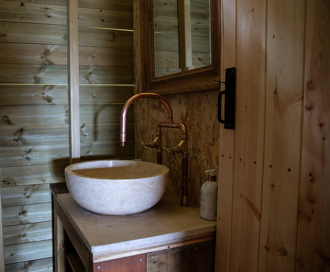 Bowl sink and copper faucet in cabin bathroom