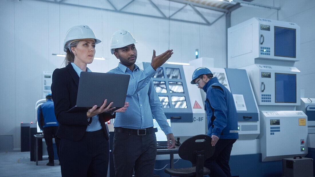 Engineer and manager talking in a factory