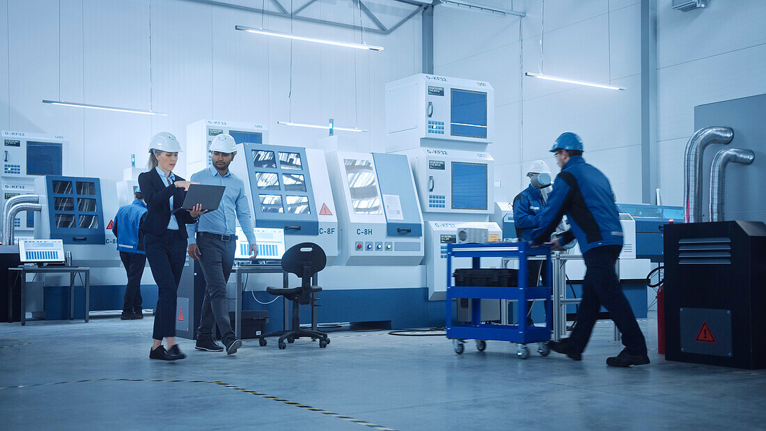 Engineer and manager talking in a factory