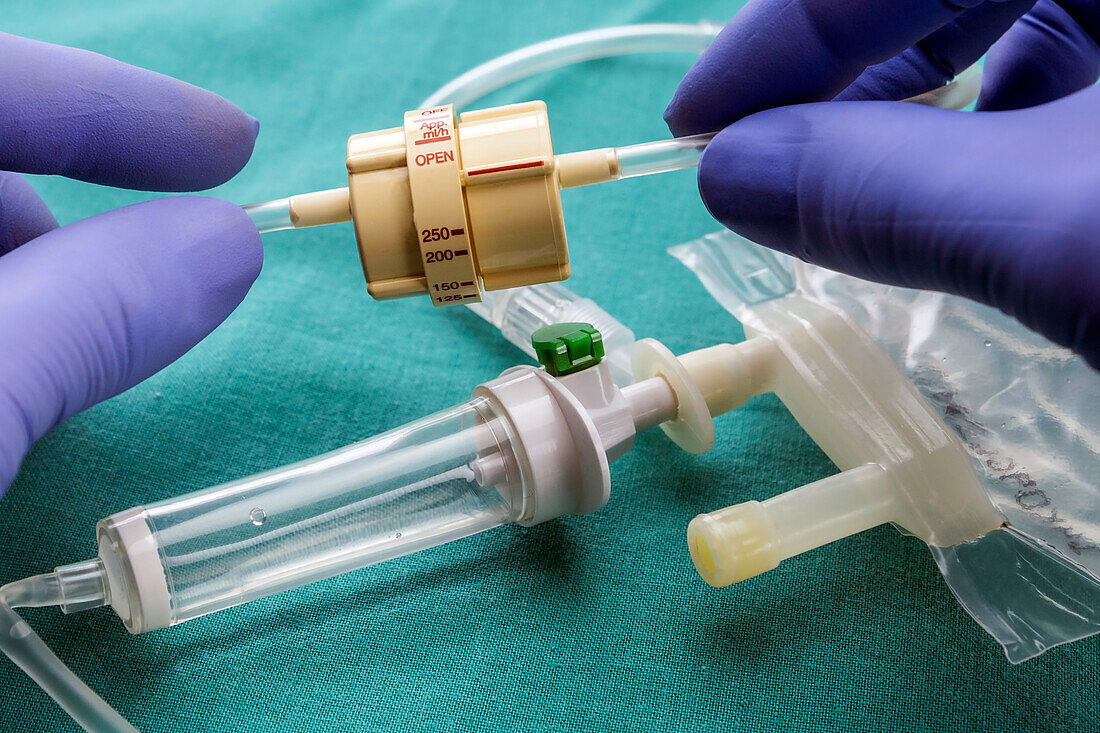 Doctor holding flow dial for IV drip