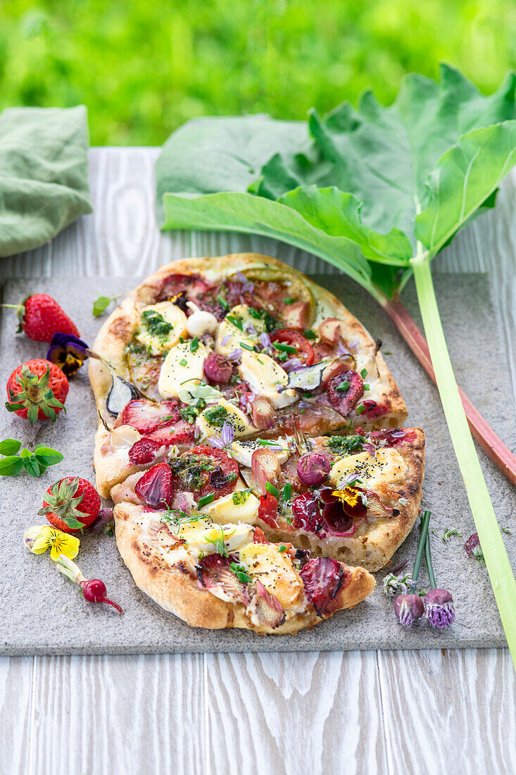 Pizza with rhubarb, spring onions, brie, strawberries and poppy seeds
