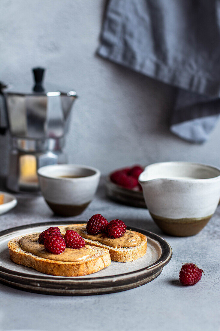 Toast with almond butter and raspberries