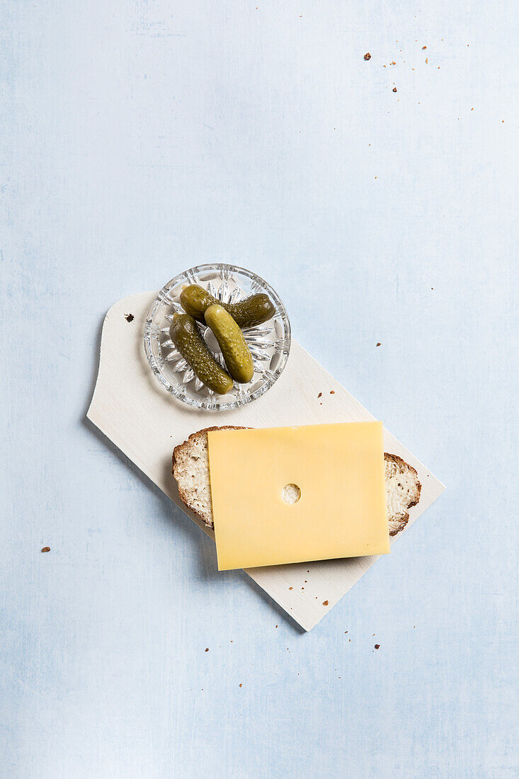 Grey bread with cheese slice, served with pickles
