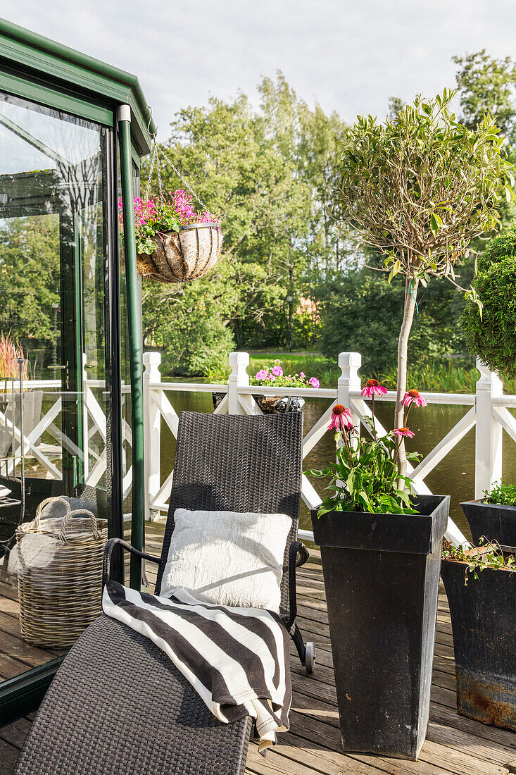 Lounger and flowerpot on the terrace of the conservatory