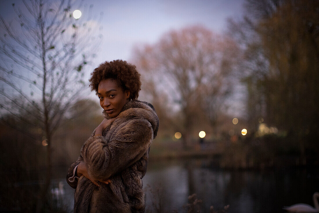 Young woman in moonlit park at night