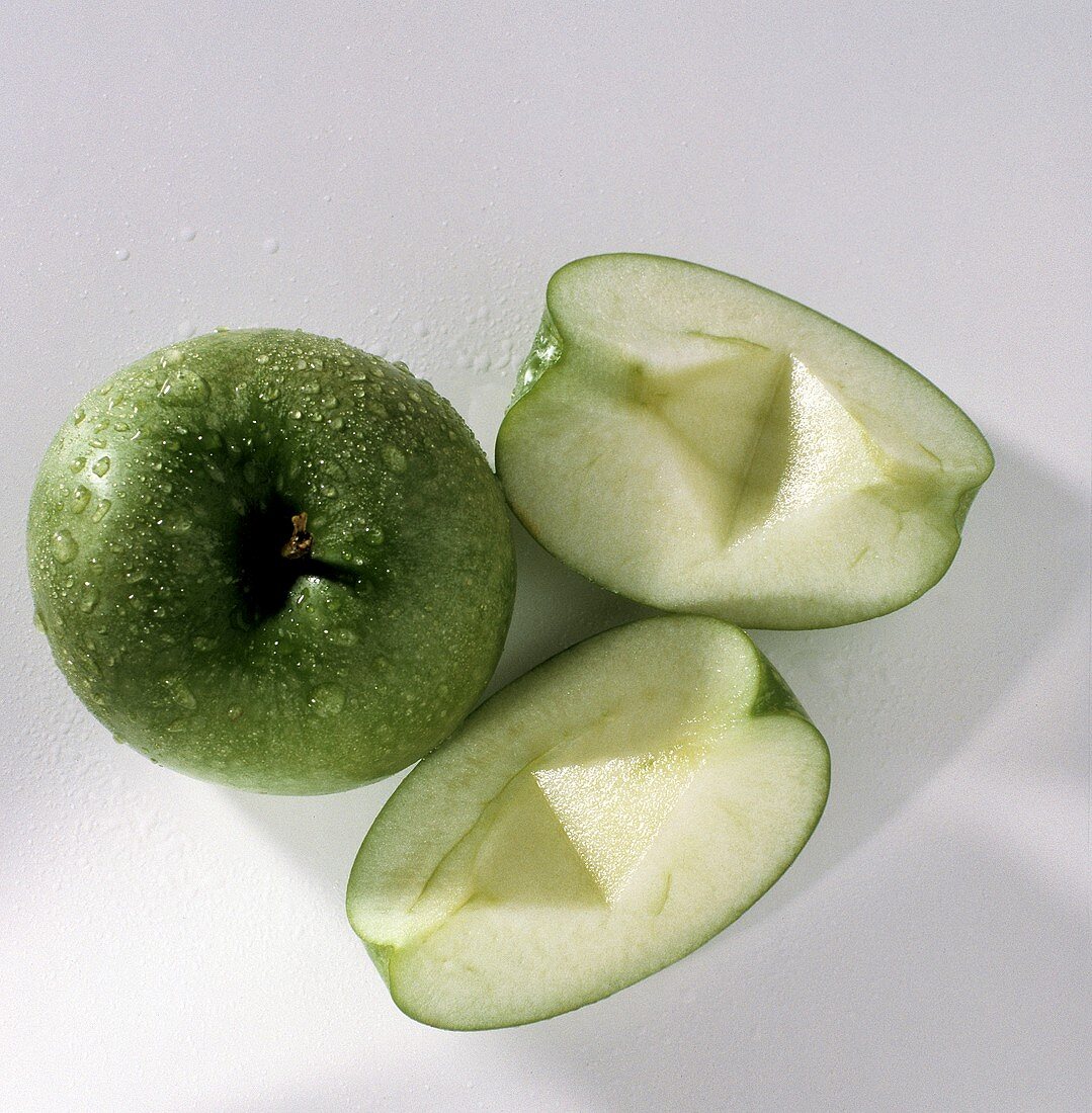 Whole Granny Smith Apple with Two Apple Wedges; Water Drops