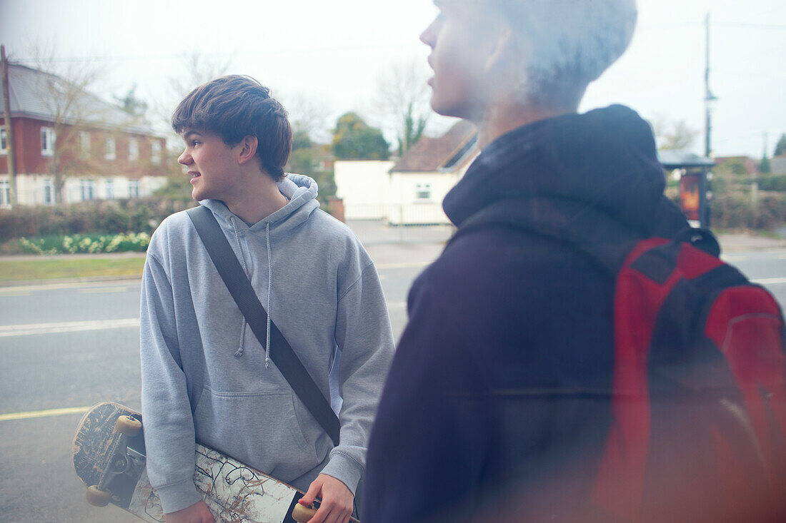 Teenage boys with skateboard on street