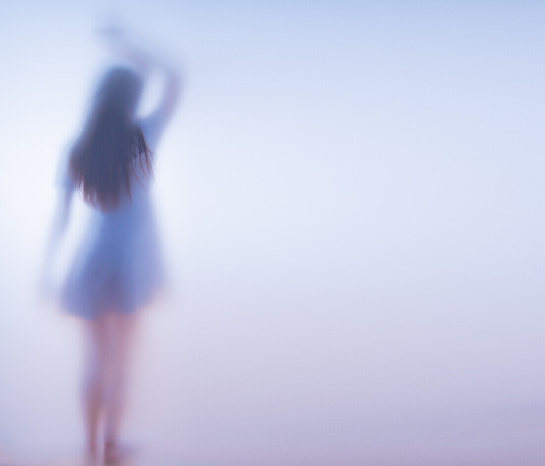Woman in a short dress behind frosted glass