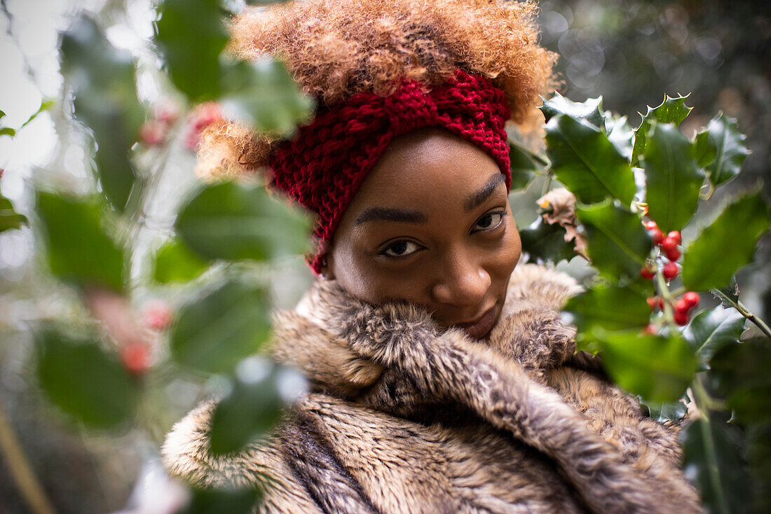 Young woman at holly bush