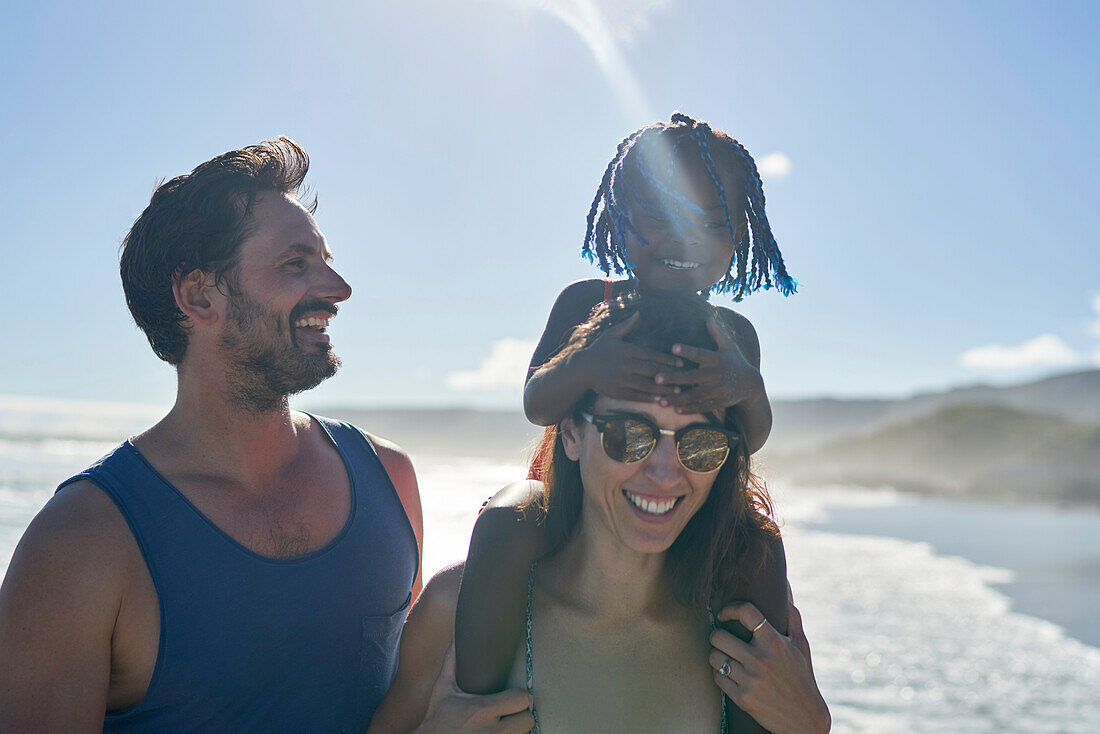 Happy family on sunny summer beach