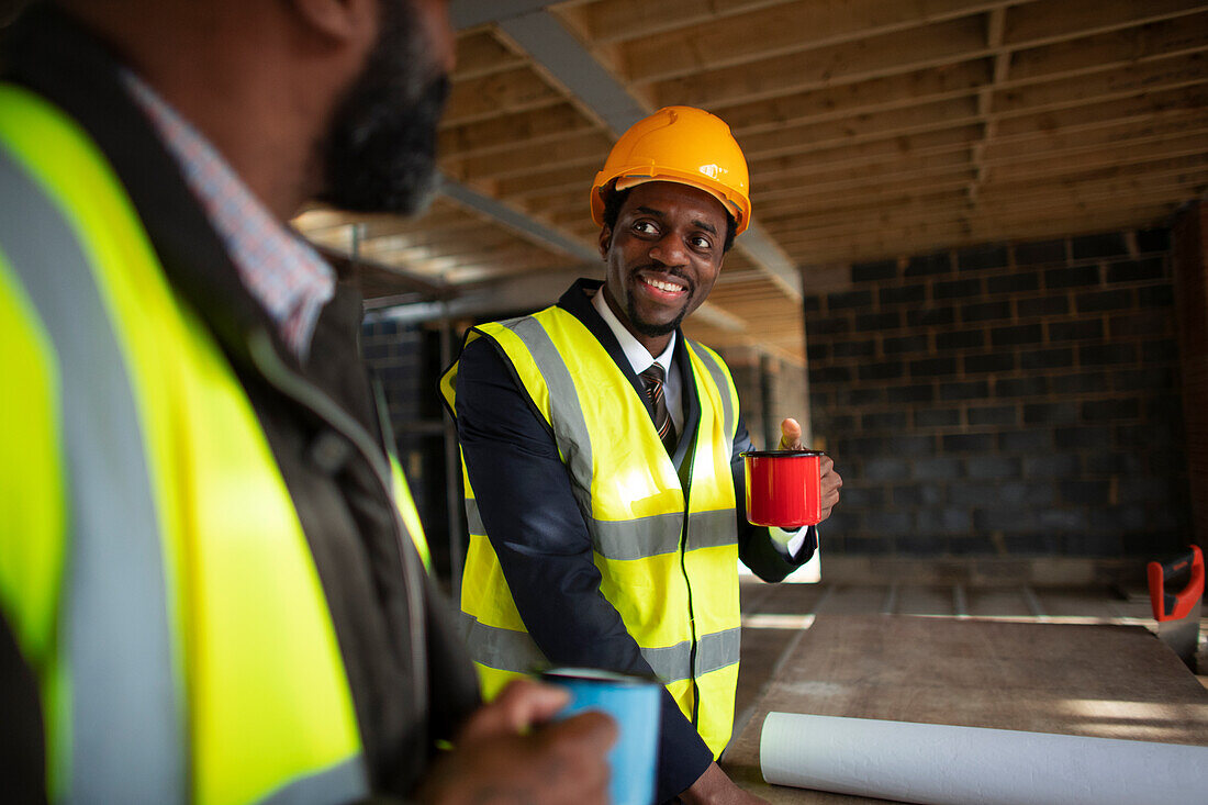 Architects drinking coffee at construction site