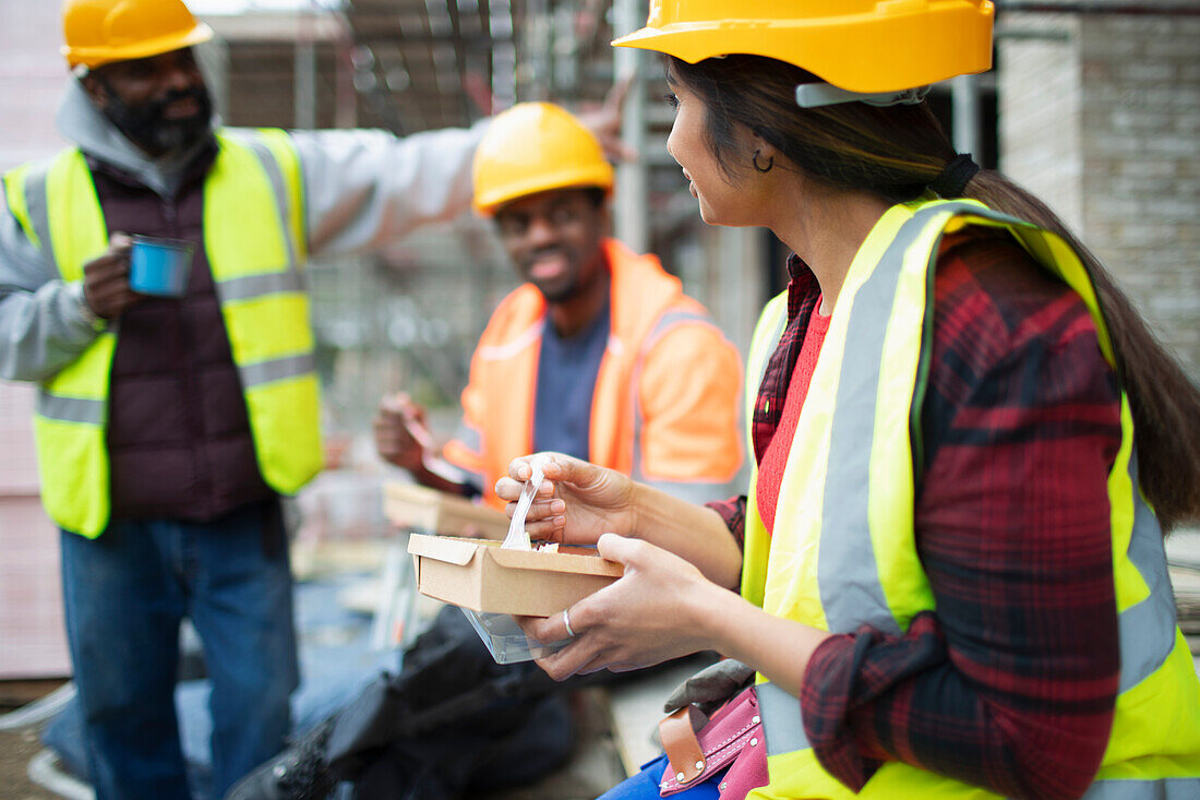 Construction workers eating lunch at construction site