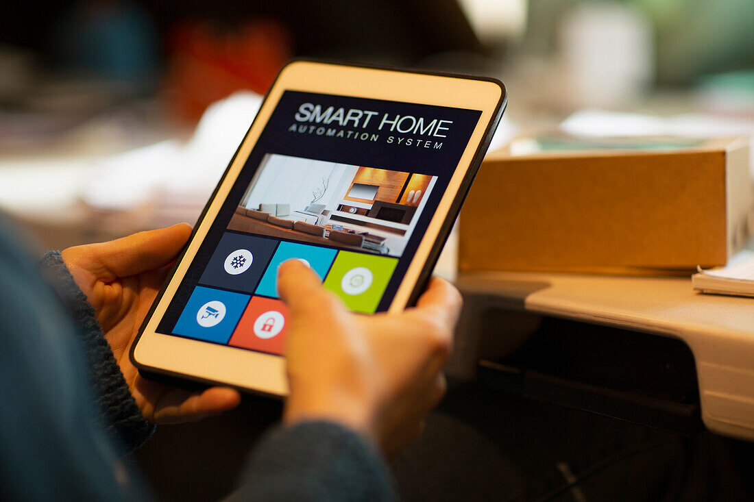 Woman looking at home automation on digital tablet