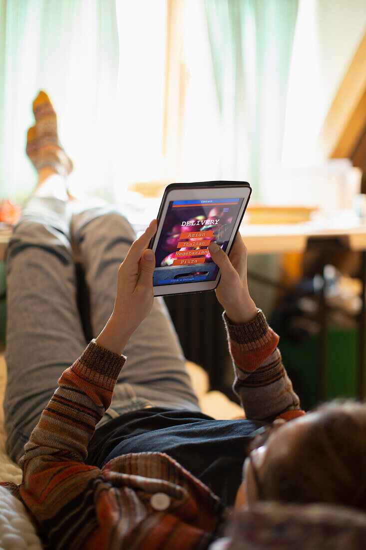 Casual woman ordering takeout food on digital tablet