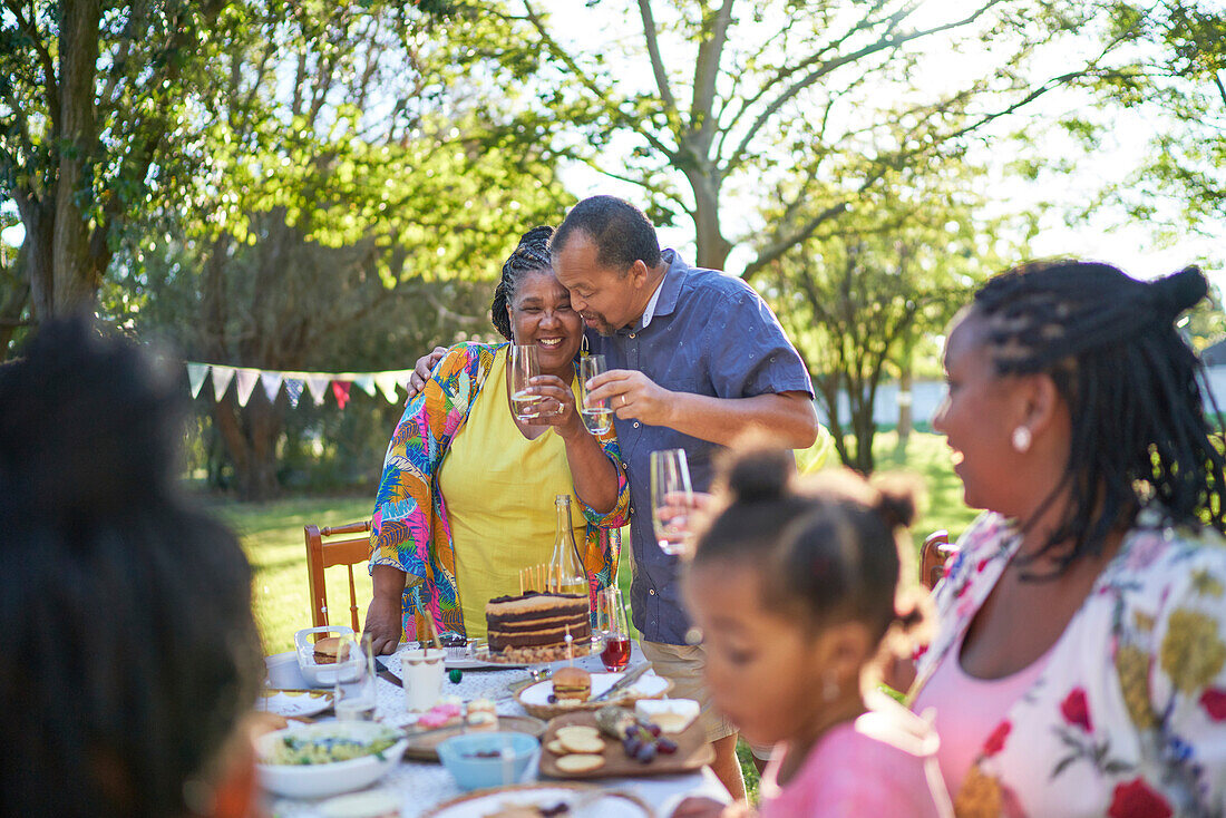 Happy couple celebrating birthday in summer garden