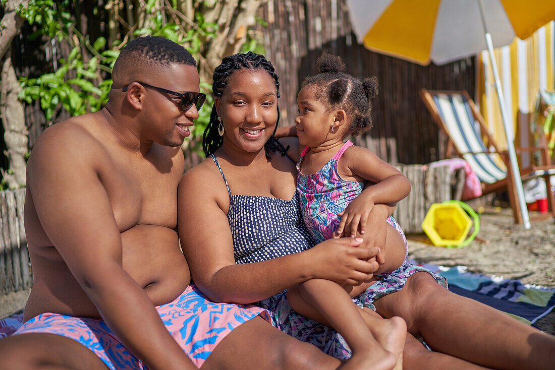 Happy family at summer poolside