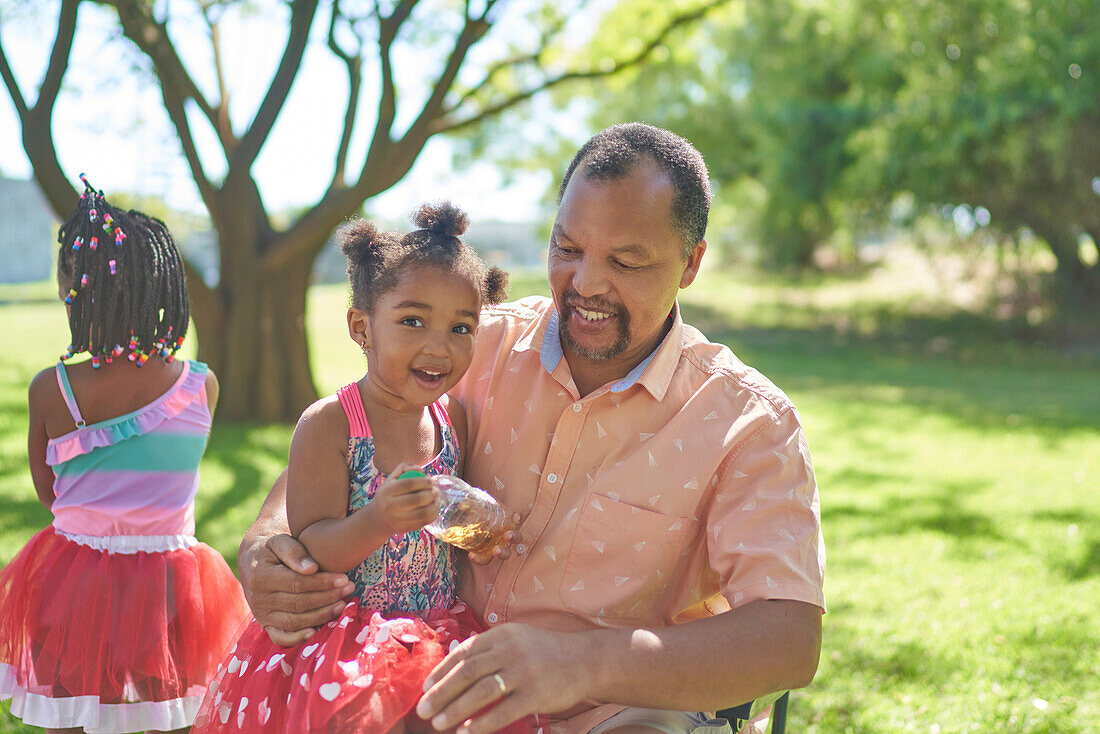 Granddaughter with grandfather in park