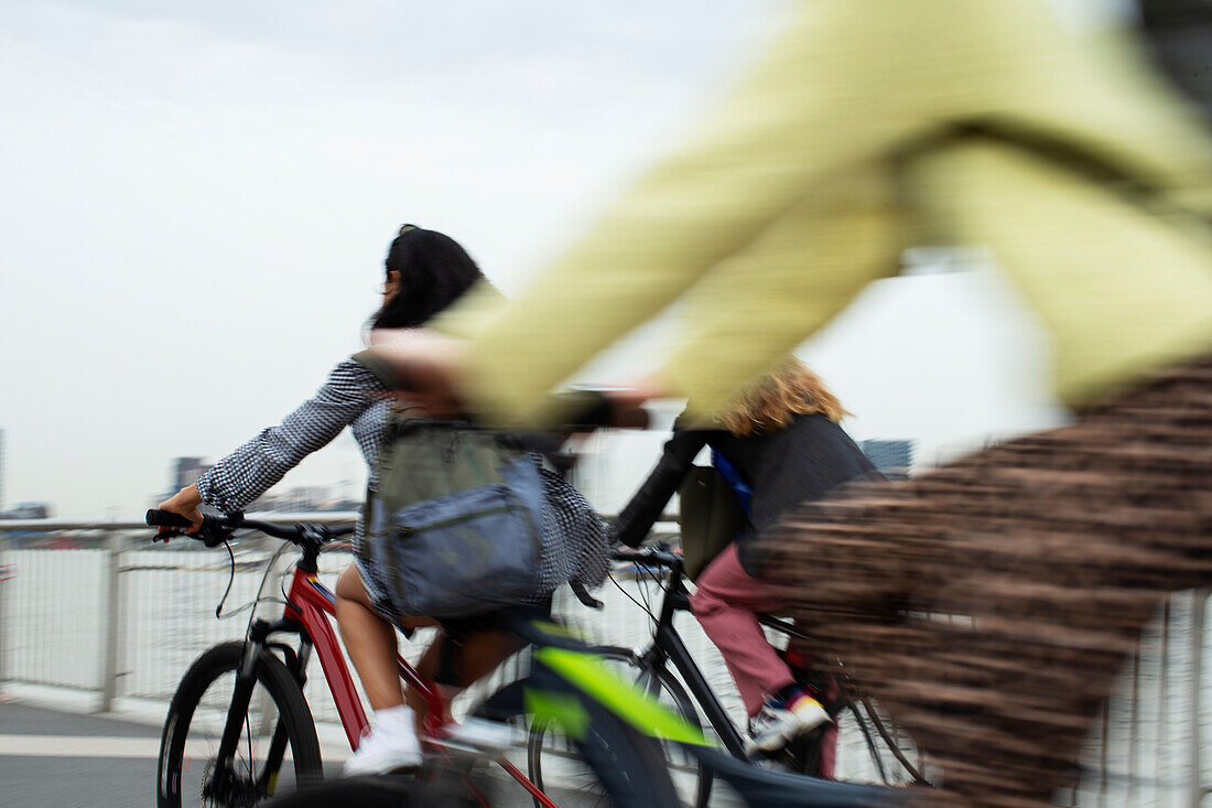 Young women speeding on bicycles