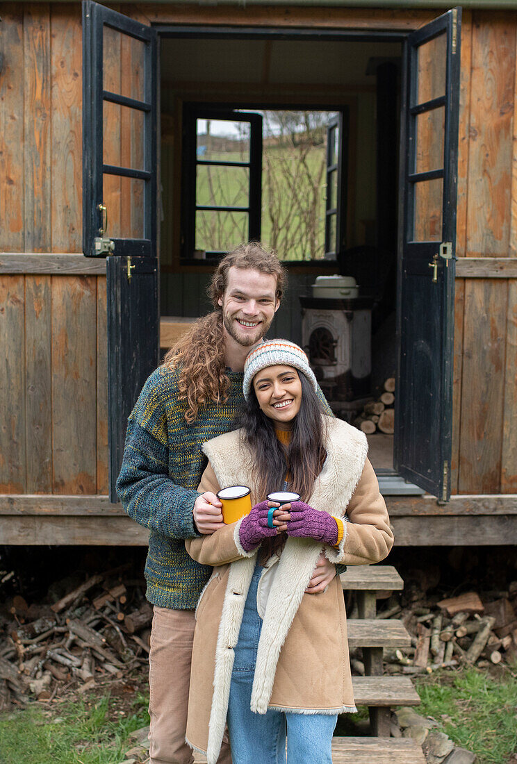 Happy couple outside tiny cabin rental
