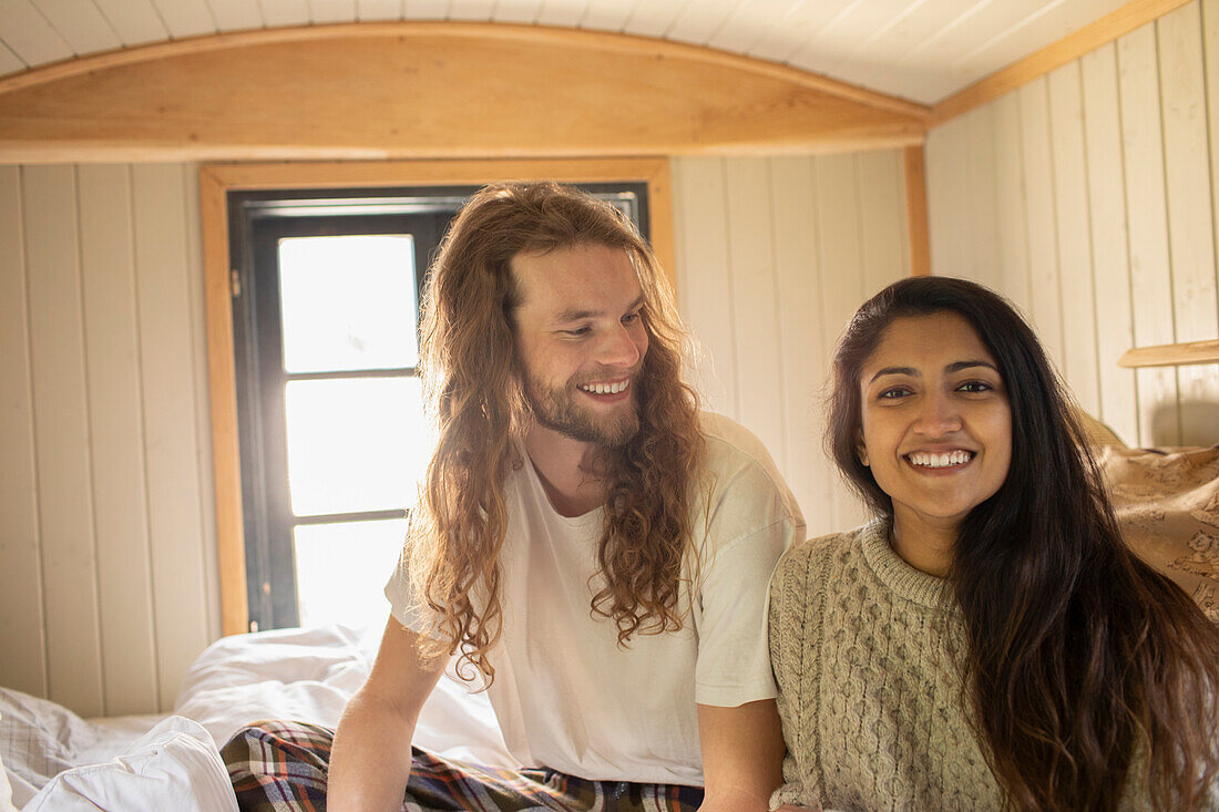 Happy young couple in bed